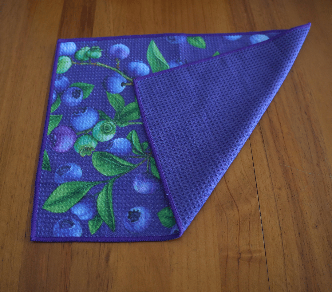 Folded DirtyGirl Berry Fresh Cloth displayed on bench – Reusable and eco-friendly