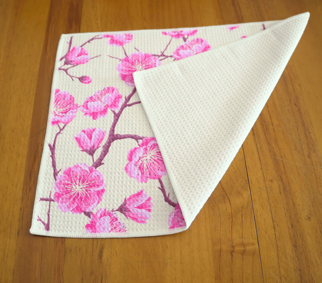 Folded DirtyGirl Blossom Bloom Cloth displayed on bench – Reusable and eco-friendly