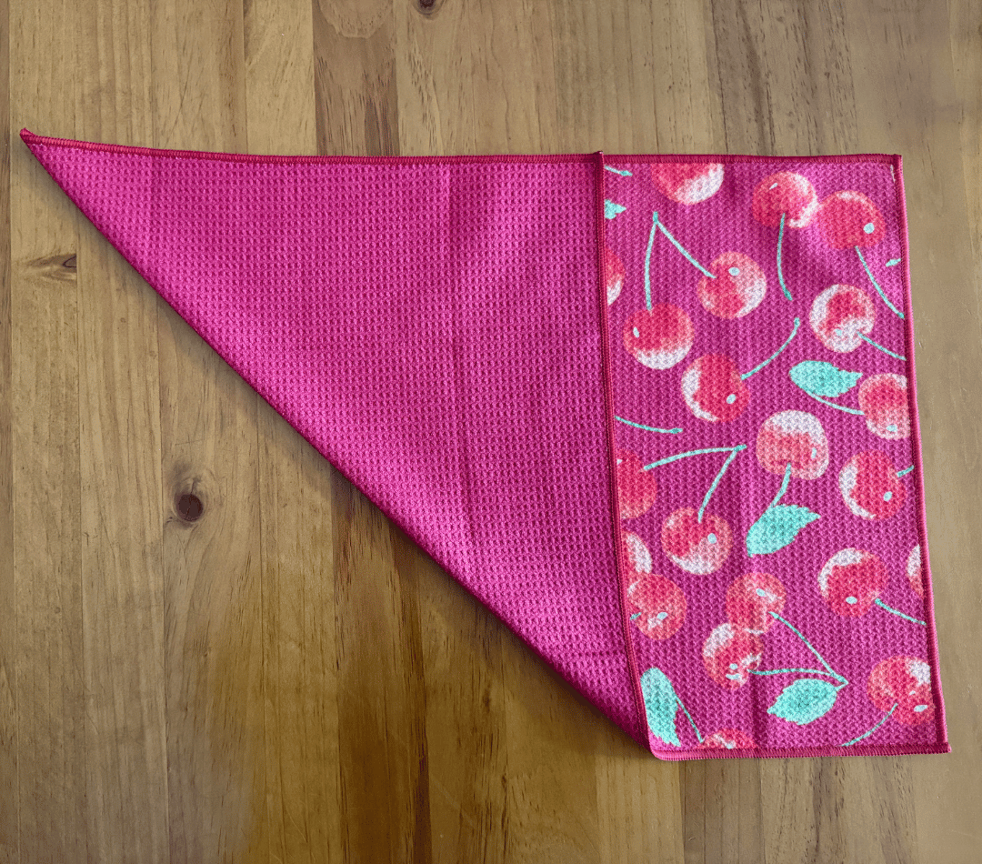 Folded DirtyGirl Cherry Crush Cloth displayed on bench – Reusable and eco-friendly