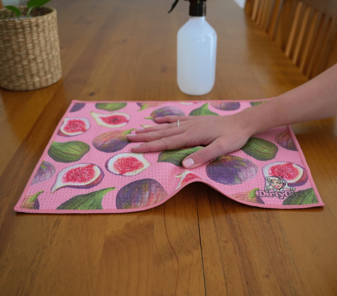 Hand wiping kitchen surface with DirtyGirl Fig Delight Cloth – Lint-free finish