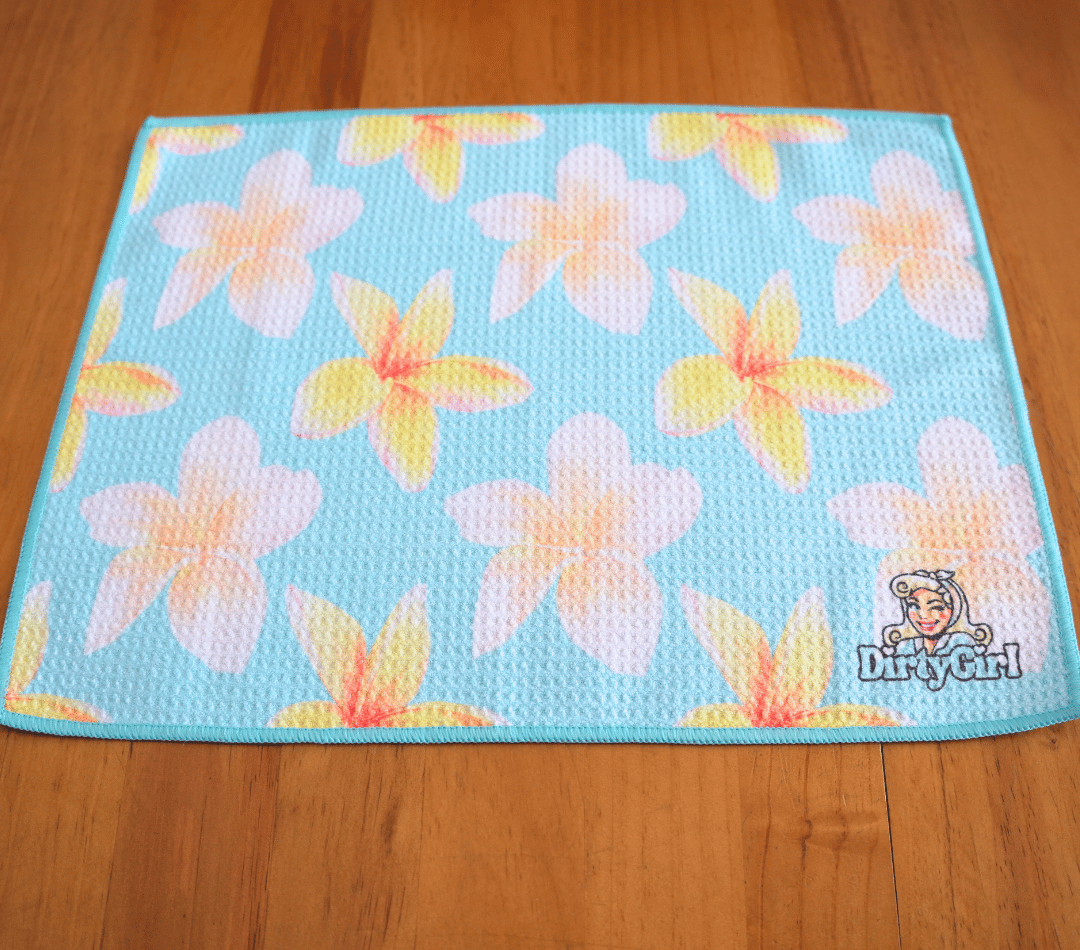 Flatlay of DirtyGirl Frangipani Breeze Cloth laid flat on benchtop – Quick-drying fabric