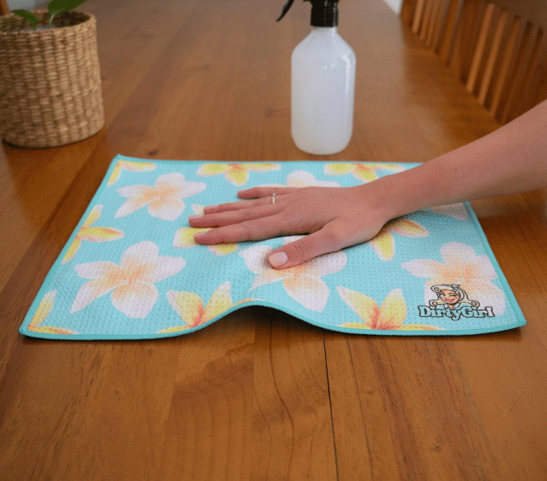 Hand wiping kitchen surface with DirtyGirl Frangipani Breeze Cloth – Lint-free finish