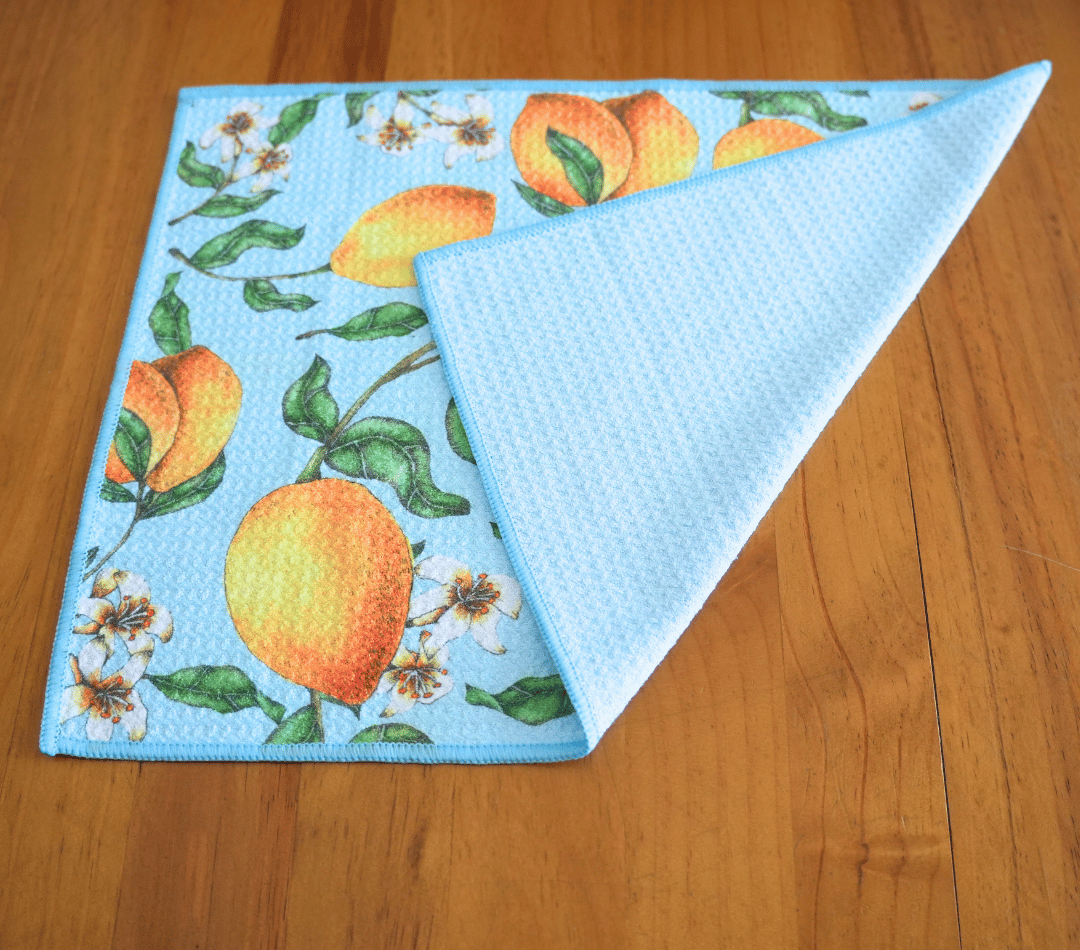 Folded DirtyGirl Lemon Twist Cloth displayed on bench – Reusable and eco-friendly
