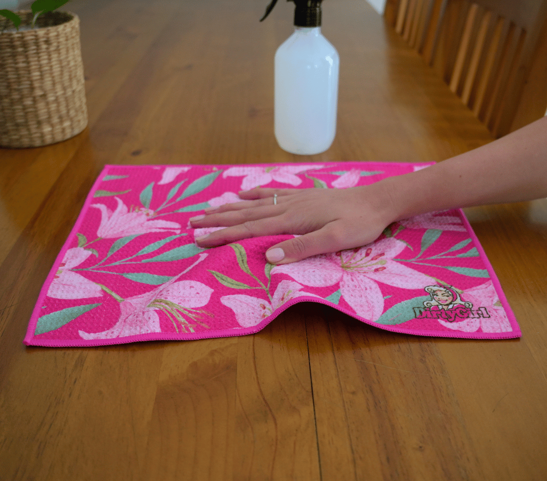 Hand wiping kitchen surface with DirtyGirl Lily Blush Cloth – Lint-free finish