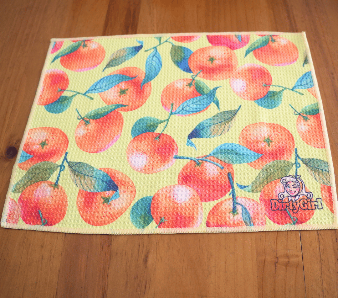 Flatlay of DirtyGirl Orange Zest Cloth laid flat on benchtop – Quick-drying fabric