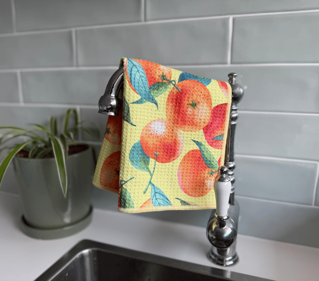 DirtyGirl Orange Zest Cloth draped over sink tap – Absorbent weave for spills