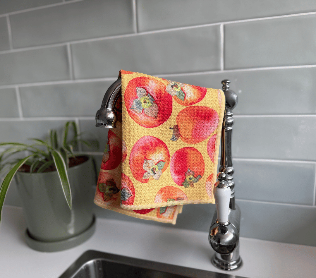 DirtyGirl Persimmon Polish Cloth draped over sink tap – Absorbent weave for spills