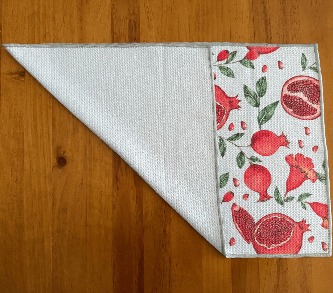 Folded DirtyGirl Pomegranate Pop Cloth displayed on bench – Reusable and eco-friendly