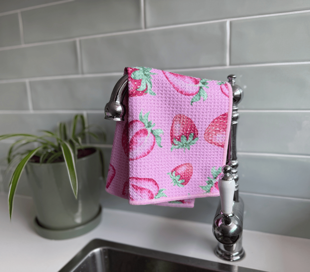 DirtyGirl Strawberry Kiss Cloth draped over sink tap – Absorbent weave for spills