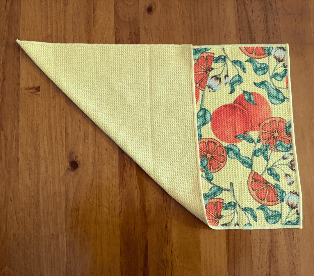 Folded DirtyGirl Tangerine Dream Cloth displayed on bench – Reusable and eco-friendly