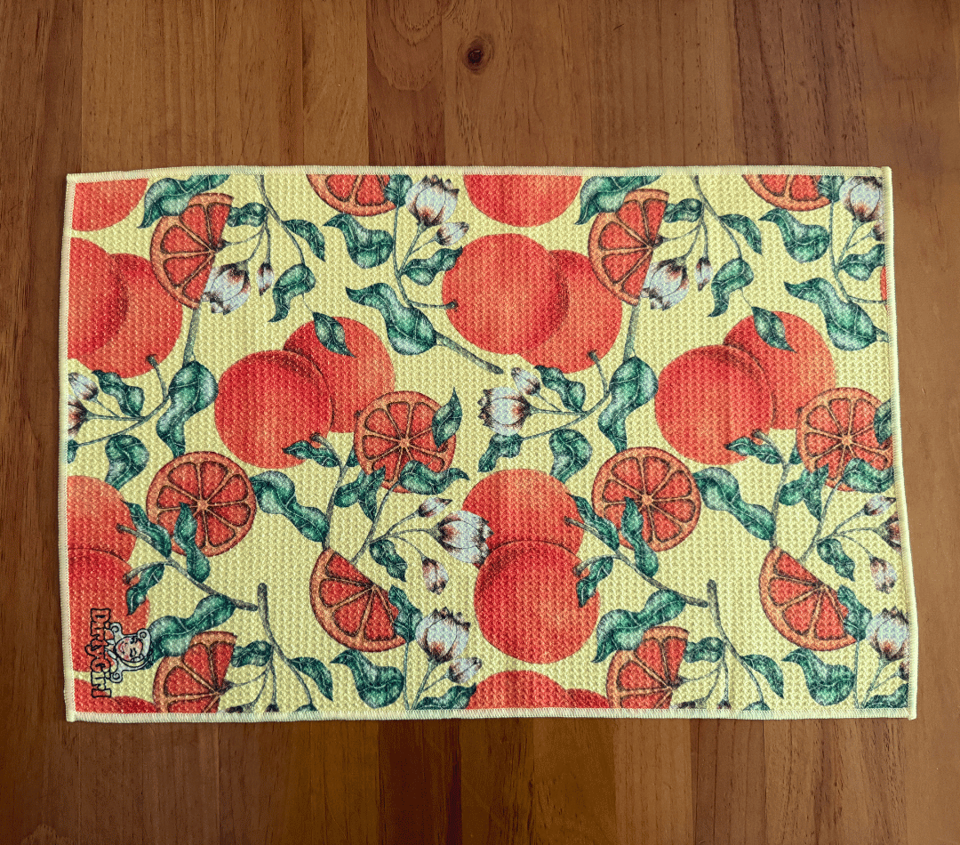 Flatlay of DirtyGirl Tangerine Dream Cloth laid flat on benchtop – Quick-drying fabric