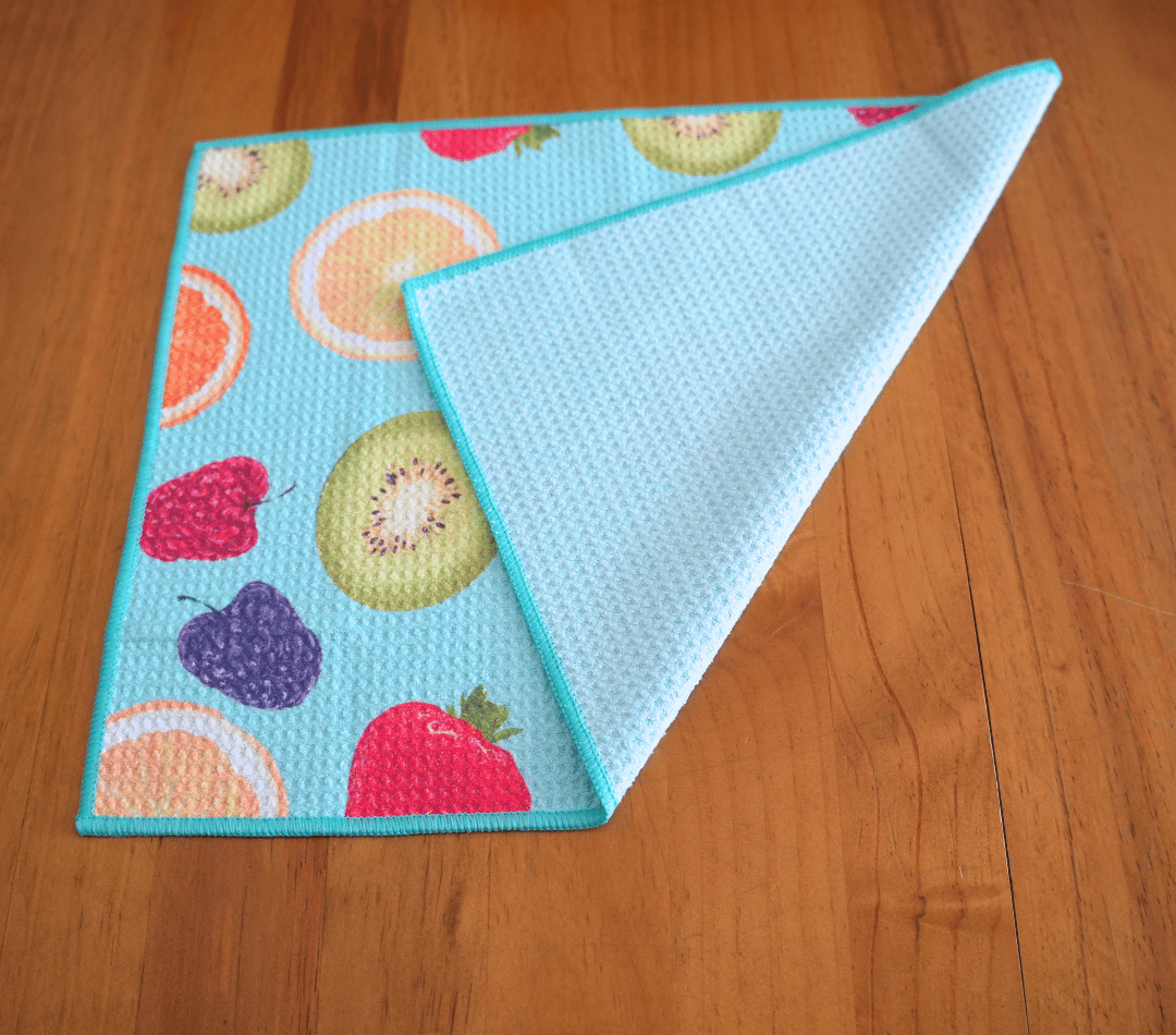 Folded DirtyGirl Tutti Frutti Cloth displayed on bench – Reusable and eco-friendly