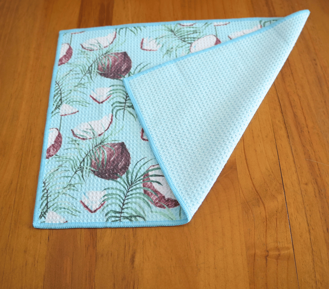 Folded DirtyGirl Coconut Glow Cloth displayed on bench – Reusable and eco-friendly
