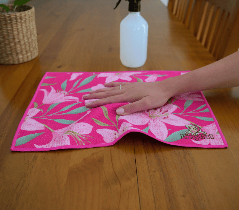 Hand wiping kitchen surface with DirtyGirl Lily Blush Cloth – Lint-free finish