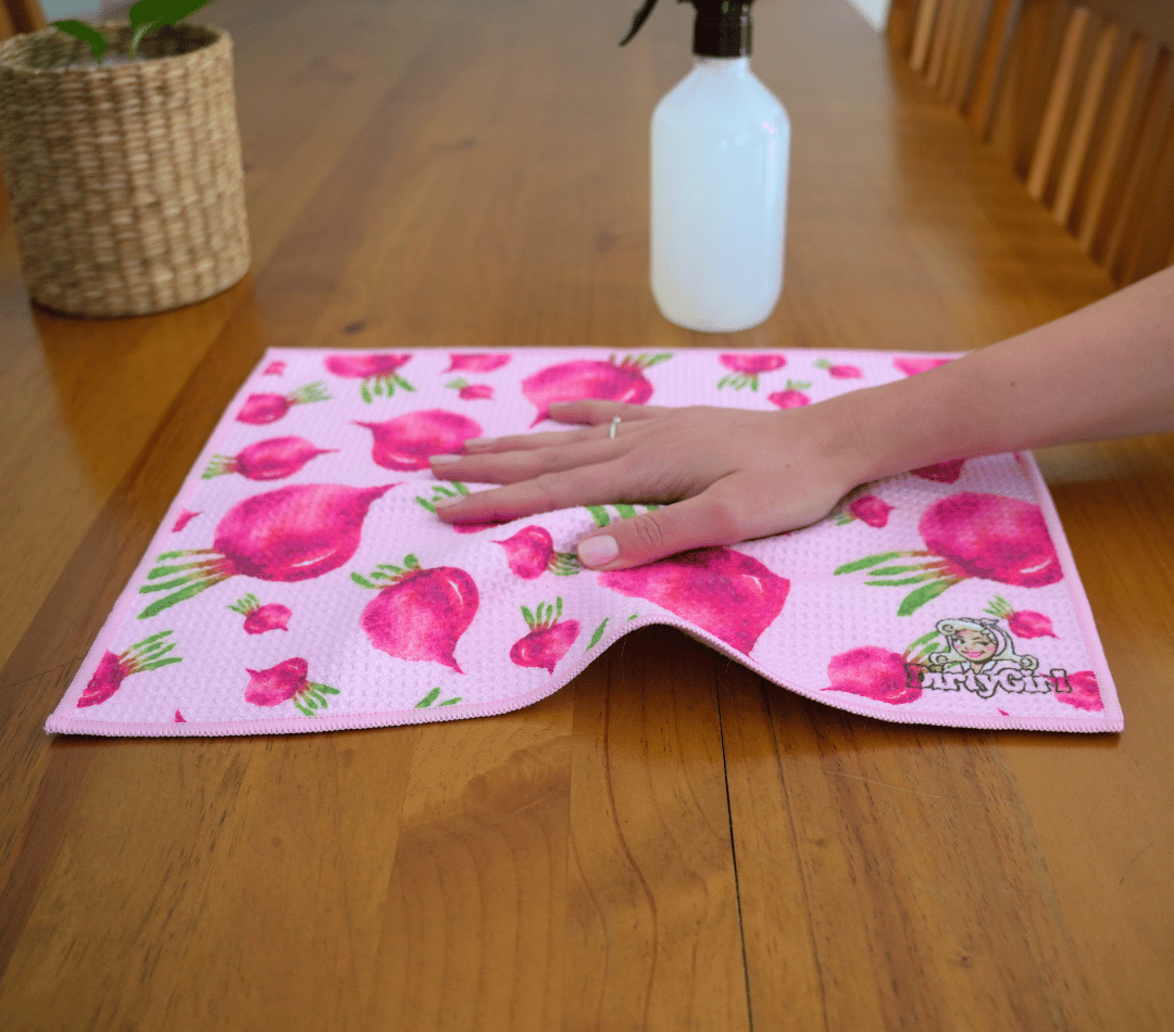 Hand wiping kitchen surface with DirtyGirl Radish Remedy Cloth – Lint-free finish